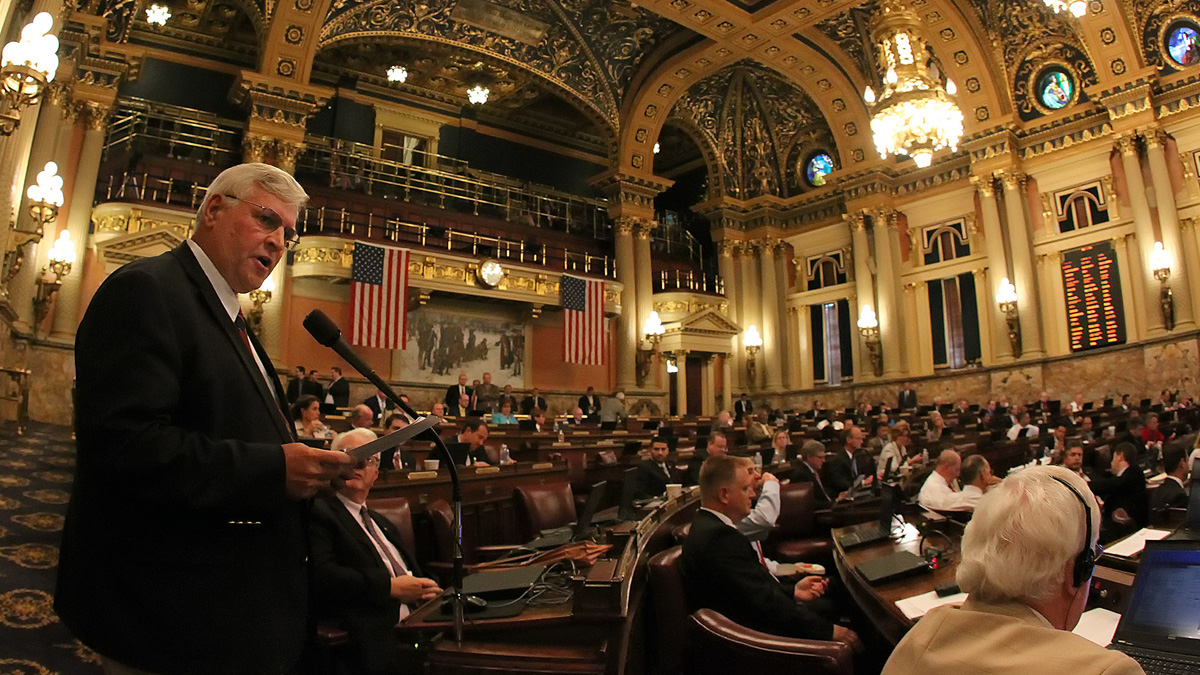  Rep. John McGinnis, R-Blair, stands to read a statement as legislators debate the budget on the floor of the House of Representatives at the Pennsylvania State Capitol in Harrisburg Tuesday. Tuesday is the last day of Pennsylvania state government's fiscal year, with lawmakers poised to make final votes on a state budget plan and other major Republican-crafted bills that appeared destined for a veto by Democratic Gov. Tom Wolf. (AP Photo/Chris Knight) 