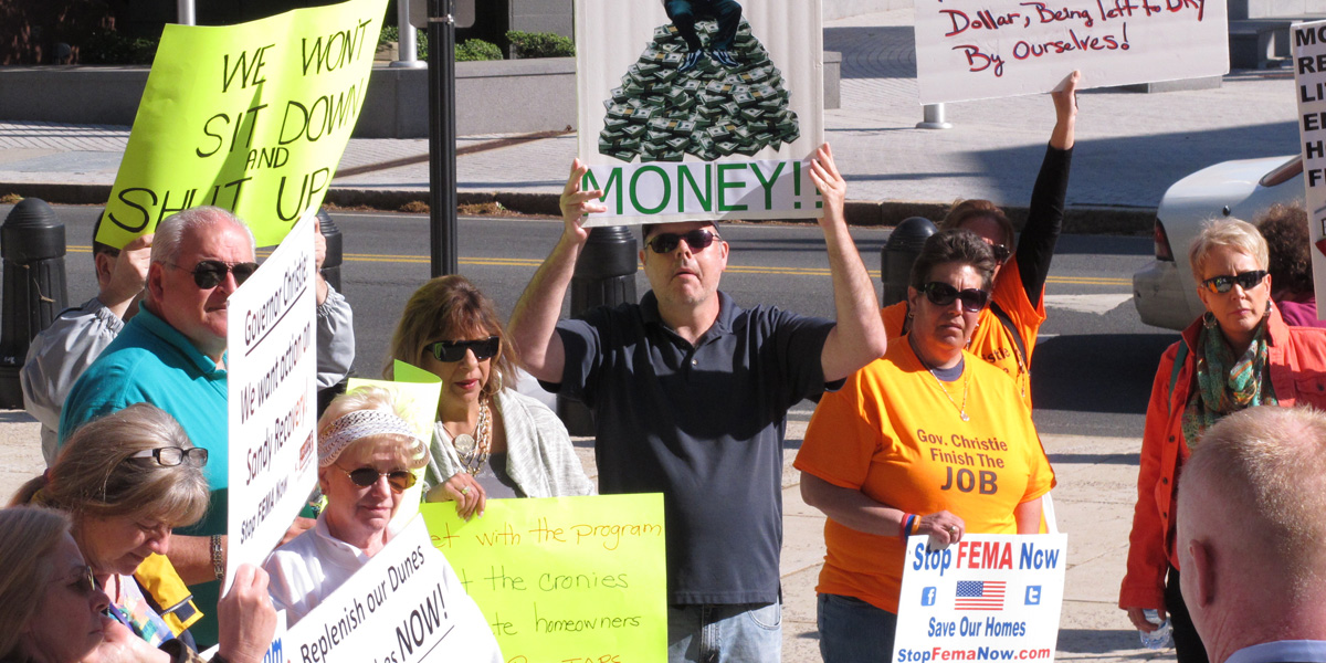  In May, demonstrators rallied outside the New Jersey State House in Trenton to protest the slow pace of recovery aid for victims of Superstorm Sandy. After a review, FEMA has started sending new payments to those who were shortchanged by the National Flood Insurance Program. (AP file  photo) 