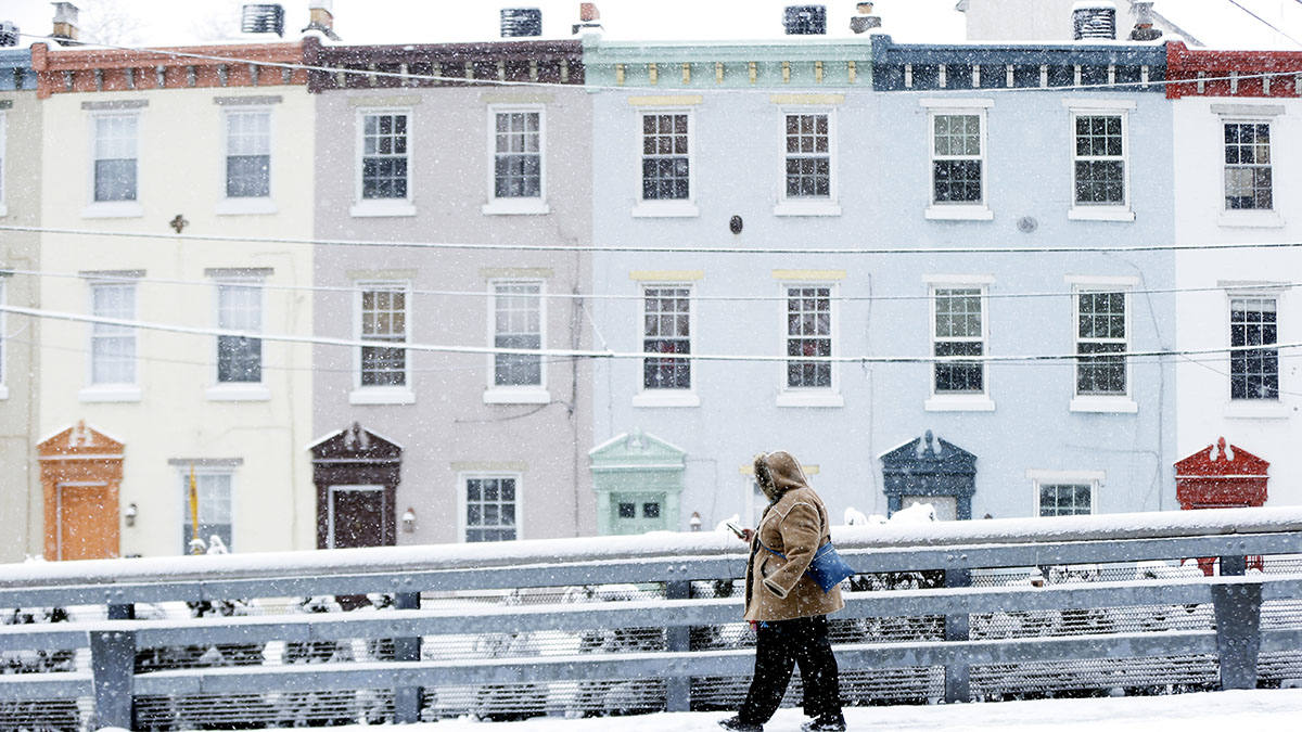 A person walks down a snow covered street in Pennsylvania. (AP Photo/Matt Rourke)