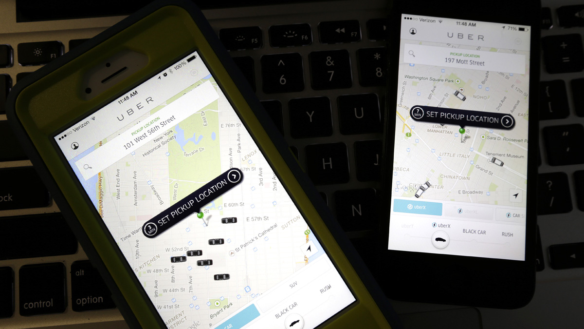 FILE - This Friday, Nov. 21, 2014 file photo taken in Newark, N.J., shows smart phones displaying Uber car availability in New York. The ride-hailing app expects this New Years Eve to be its busiest night ever. Due to such high demand, and because it can, Uber is bringing back its surge pricing, a boon to drivers and a bane to passengers. Fares can increase by as much as sevenfold during the busiest time, which Uber says will be between 12:30 a.m. and 2:30 a.m.(AP Photo/Julio Cortez, File)