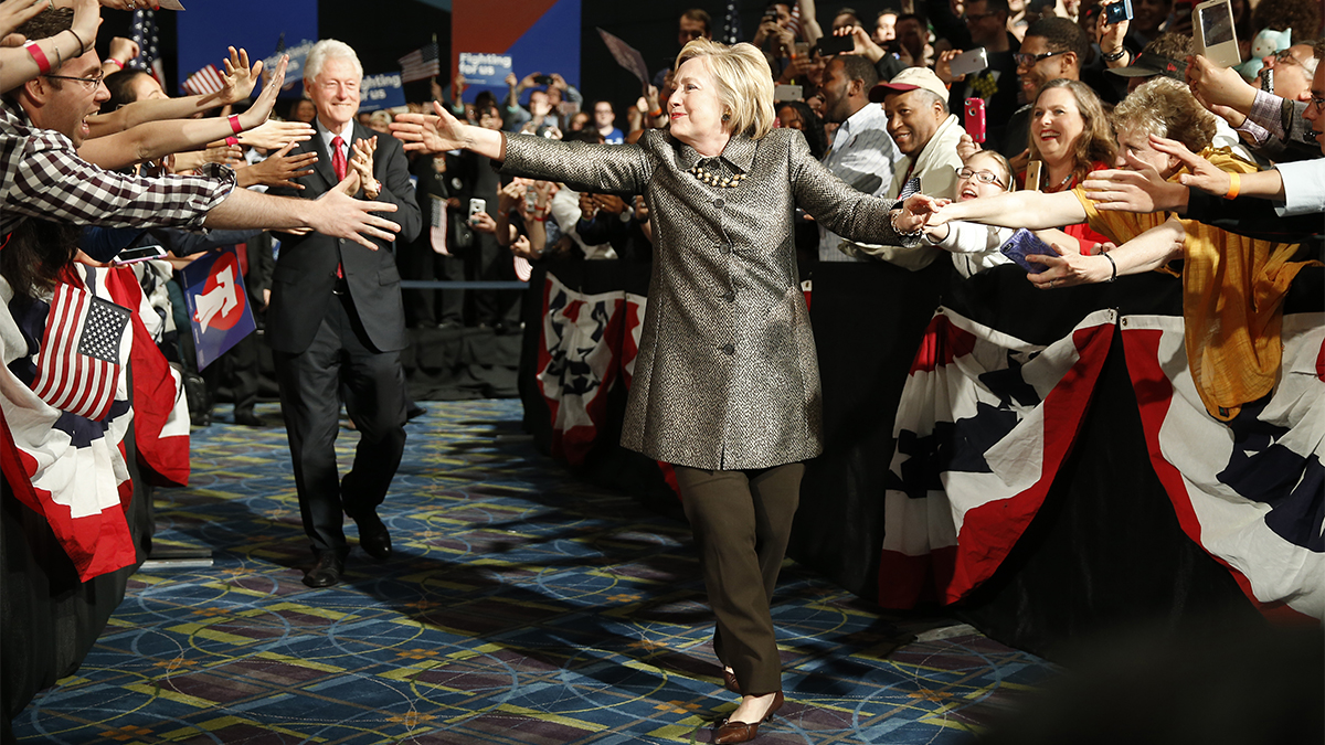 Democratic presidential candidate Hillary Clinton and Former President Bill Clinton move to the stage at her presidential primary election night rally