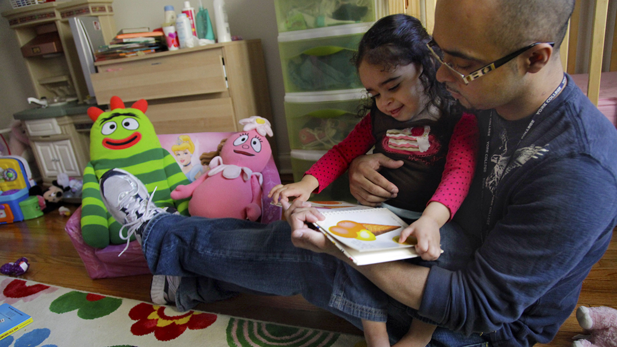  Christopher Astacio reads with his daughter Cristina, 2, diagnosed with a mild form of autism, in her bedroom in this Wednesday, March 28, 2012 file photo in New York. (Bebeto Matthews/AP Photo) 
