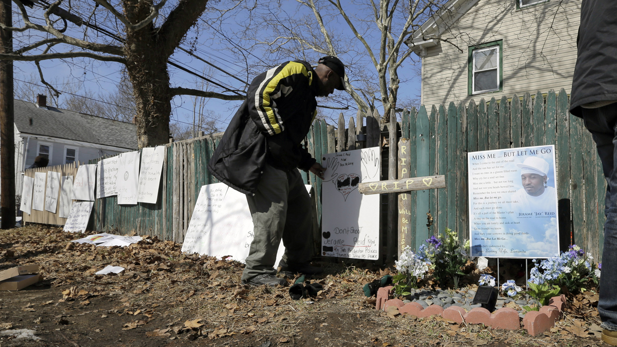  A man looks at signs near a memorial at the spot where Jerame Reid, was fatally shot by police in Bridgeton, N.J., Saturday, Feb. 28, 2015. A large group took part in a protest Saturday, which stemmed from the Dec. 30 shooting of Reid. The 36-year-old Bridgeton man was shot and killed by police during a traffic stop that was captured by a patrol car camera. (Mel Evans/AP Photo) 