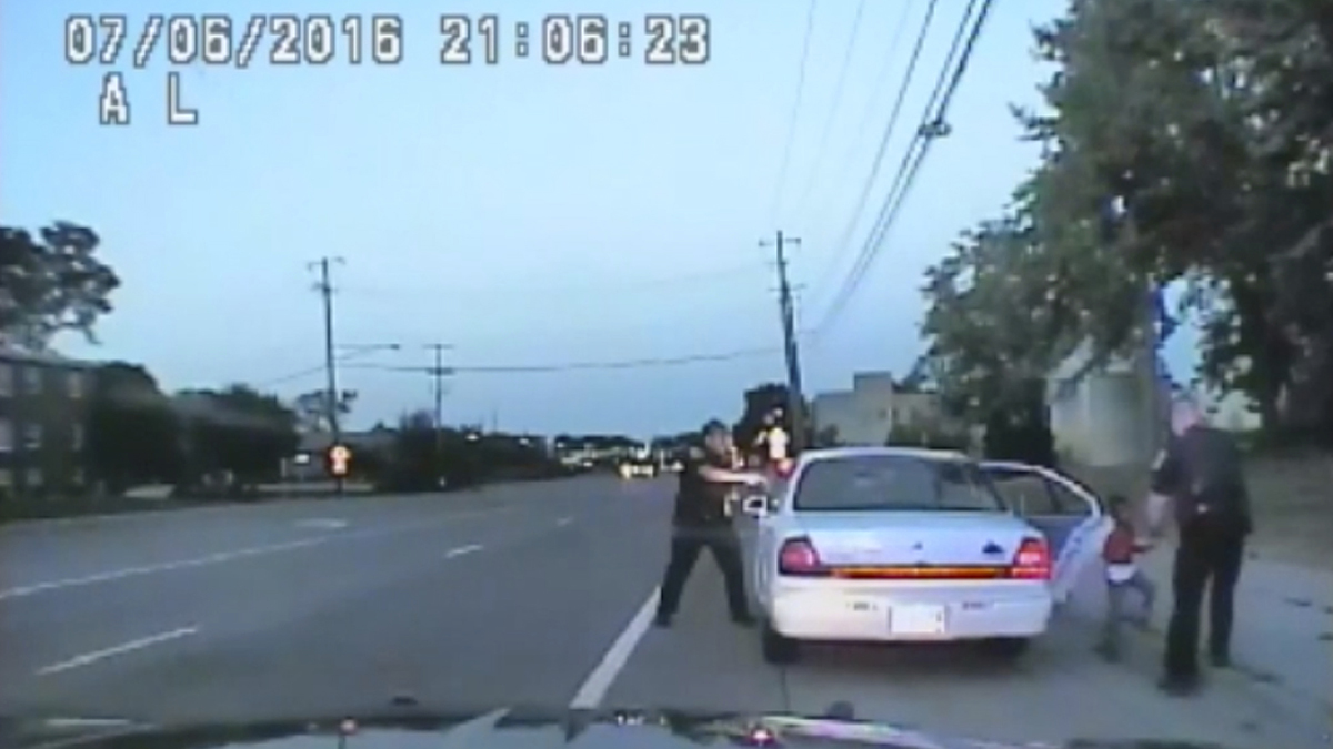  In this image made from July 6, 2016, video captured by a camera in the squad car of St. Anthony Police officer Jeronimo Yanez, the Minnesota police officer is shown after shooting into the vehicle at Philando Castile during a traffic stop in Falcon Heights, Minn., as the 4-year-old daughter of Castile's girlfriend, Diamond Reynolds, starts to get out of the car and is grabbed by an officer. The video was made public by the Minnesota Bureau of Criminal Apprehension and the Ramsey County Attorney's Office, Tuesday, June 20, 2017, just days after the officer was acquitted on all counts in the case. (St. Anthony Police Department via AP) 