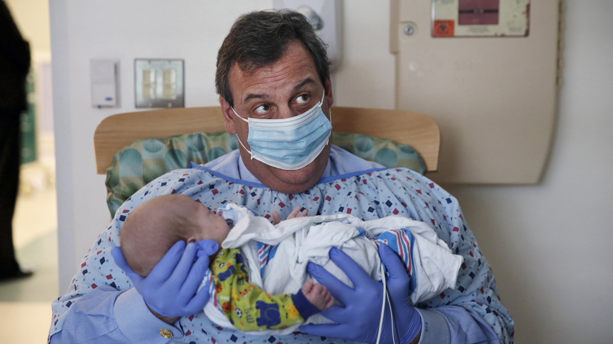 In this Tuesday, Dec. 6, 2016, file photo, New Jersey Gov. Chris Christie holds a 49-day-old baby boy being treated for neonatal drug withdrawal after his mother took opioids during pregnancy, at the Neonatal Intensive Care Unit at Jersey Shore University Medical Center in Neptune Township, N.J. (Mel Evans/AP Photo)   