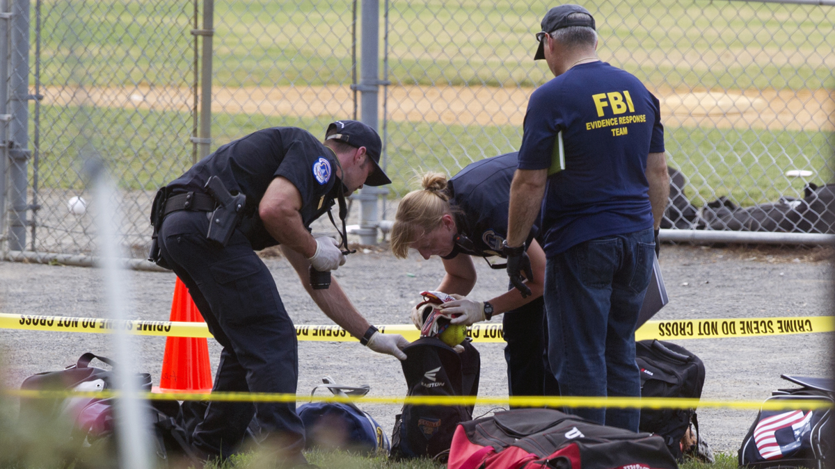  An FBI Evidence Response team inspects the contents of one of the many bags left at the scene of a shooting in Alexandria, Va., Wednesday, June 14, 2017, involving House Majority Whip Steve Scalise of La., and others, during a congressional baseball practice. (Cliff Owen/AP Photo) 