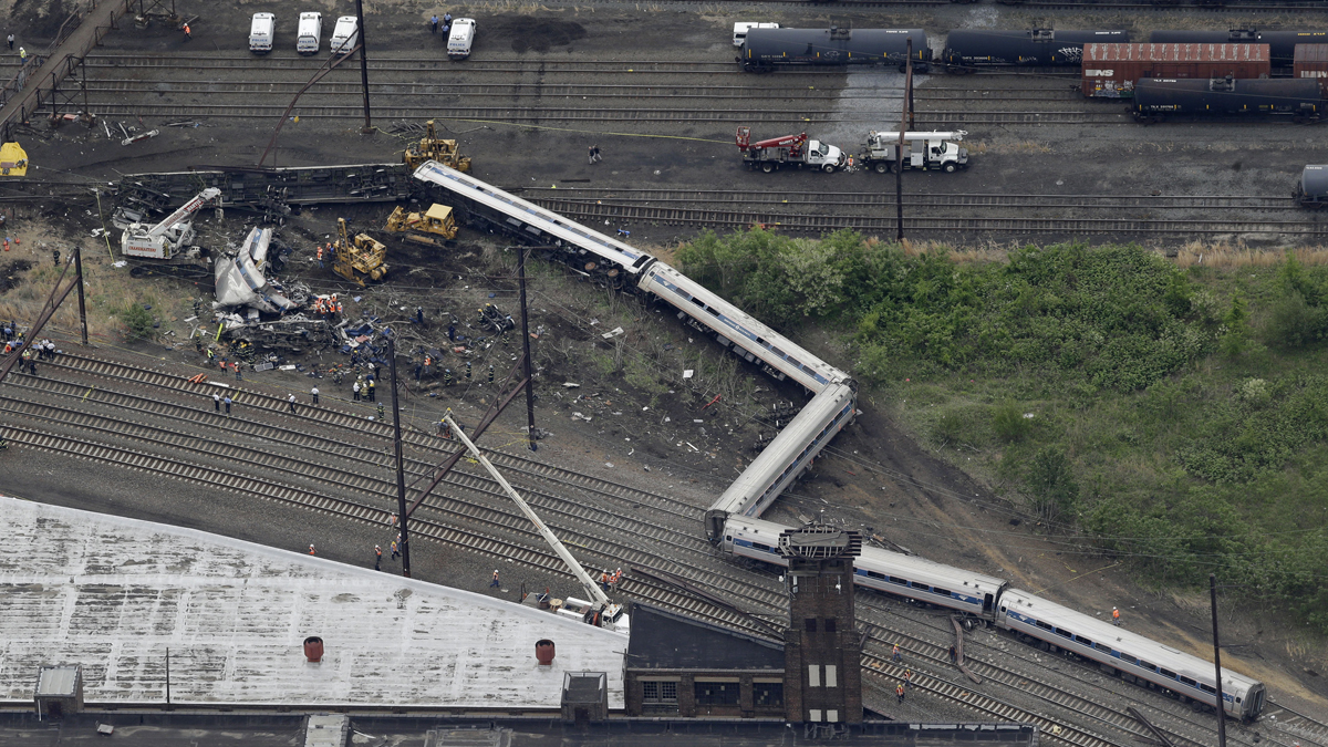  Emergency personnel work at the scene of a deadly train derailment, Wednesday, May 13, 2015, in Philadelphia. The Amtrak train, headed to New York City, derailed and crashed in Philadelphia on Tuesday night, killing at least six people and injuring dozens of others. (AP Photo/Patrick Semansky) 