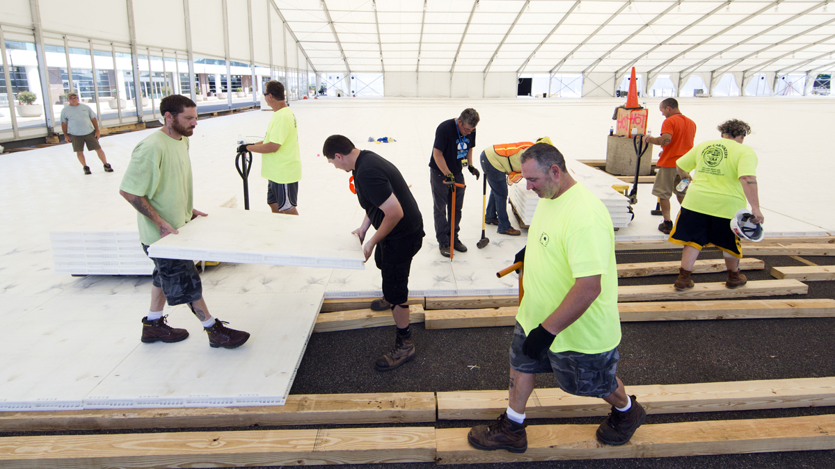 Workers assemble flooring in Temporary structures outside the Wells Fargo Center ahead of the the 2016 Democratic National Convention in Philadelphia