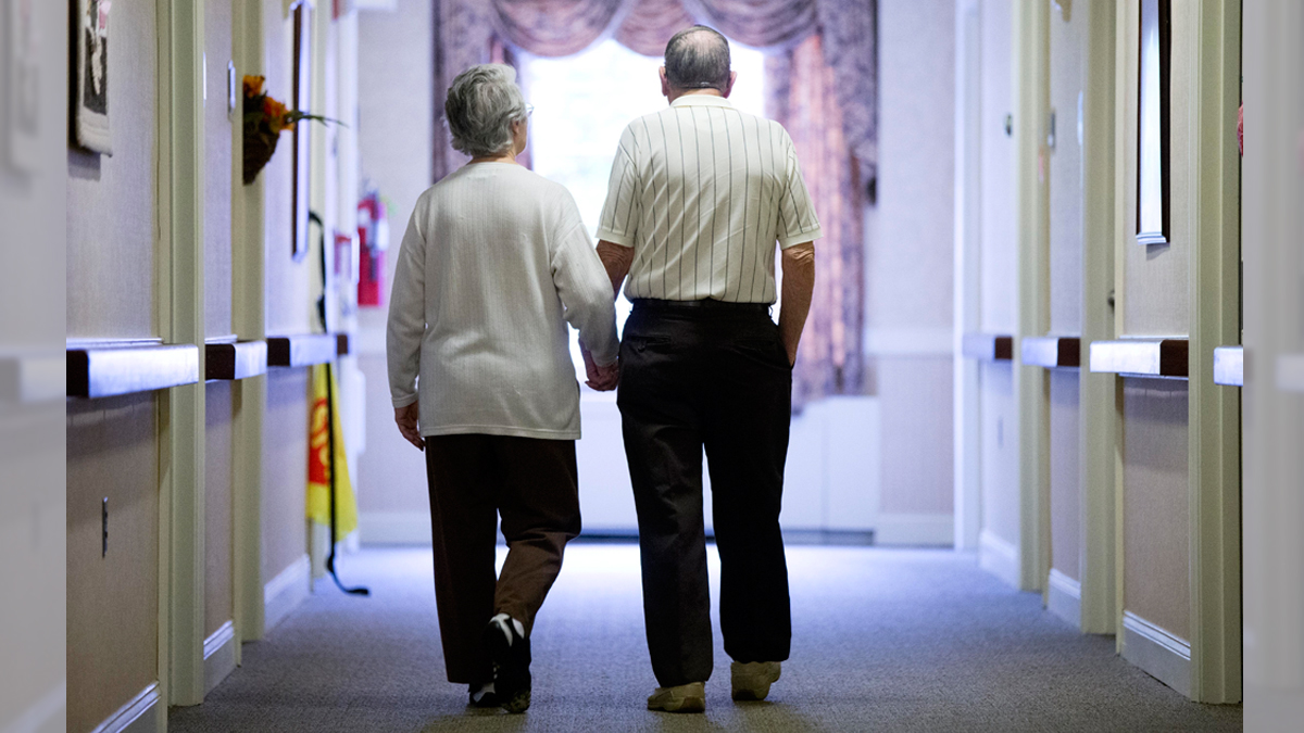 In this Nov. 6, 2015 file photo, an elderly couple walks down a hall in Easton, Pa. (Matt Rourke/AP Photo, File) 