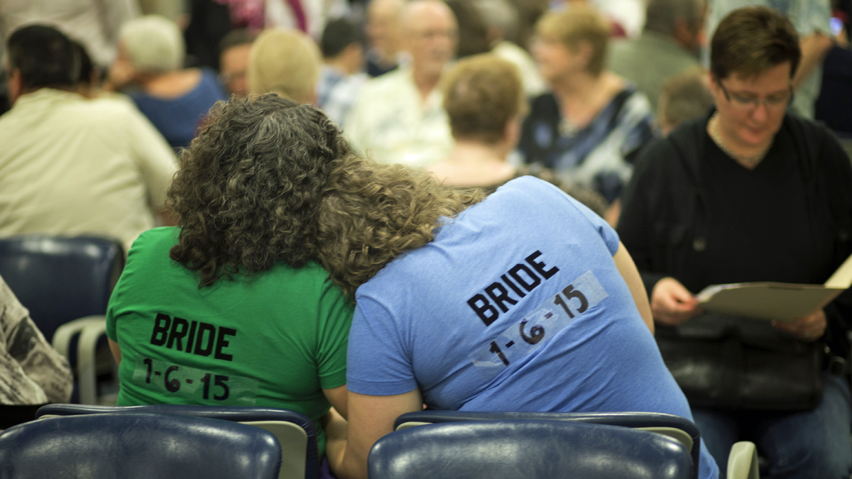  Cristina Jimenez, (left), hugs her future bride, Liz Mabry, as they wait for their marriage license, Monday, Jan. 5, 2015 in Delray Beach, Fla. The couple has been together for 10 years. Florida's ban on same-sex marriage ended statewide at the stroke of midnight Monday, and court clerks in some Florida counties wasted no time, issuing marriage licenses overnight to same-sex couples. (J. Pat Carter/AP Photo) 