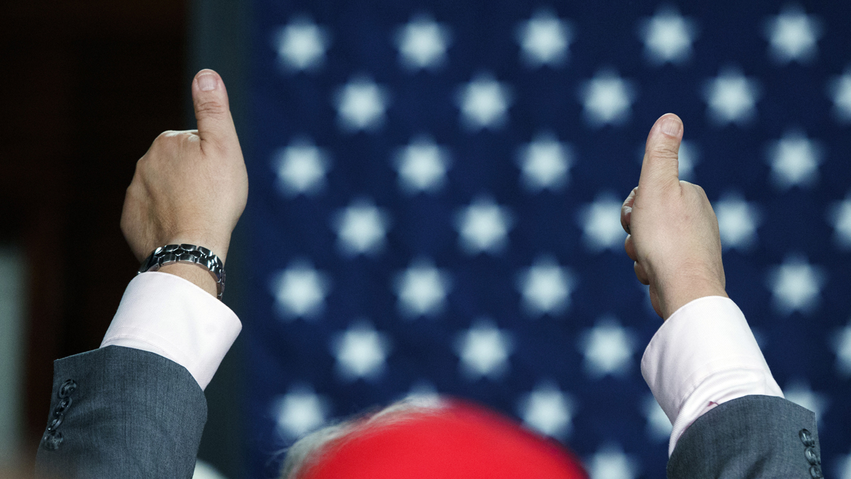 A supporter of Republican presidential candidate Donald Trump gives a thumbs up during a town hall