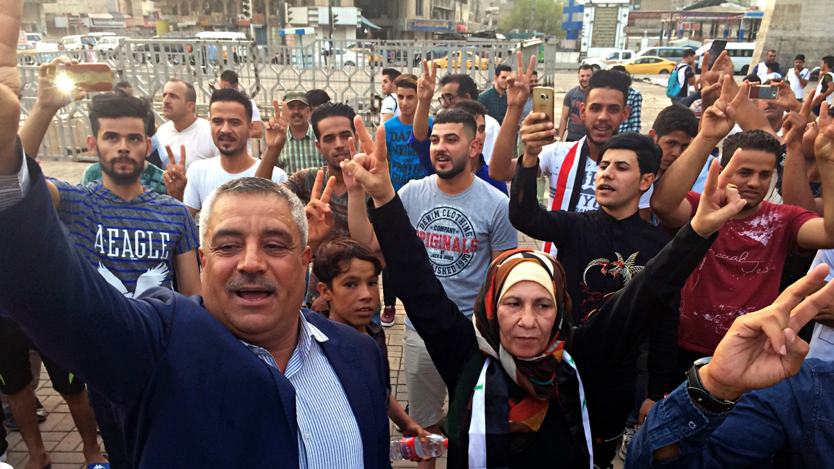  Iraqis celebrate in Tahrir square as they wait for the final announcement of the defeat of the Islamic state militants, in Baghdad, Iraq, Sunday, July 9, 2017. Backed by the U.S.-led coalition, Iraq launched the operation to retake Mosul from Islamic State militants in October. (Hadi Mizban/AP Photo) 
