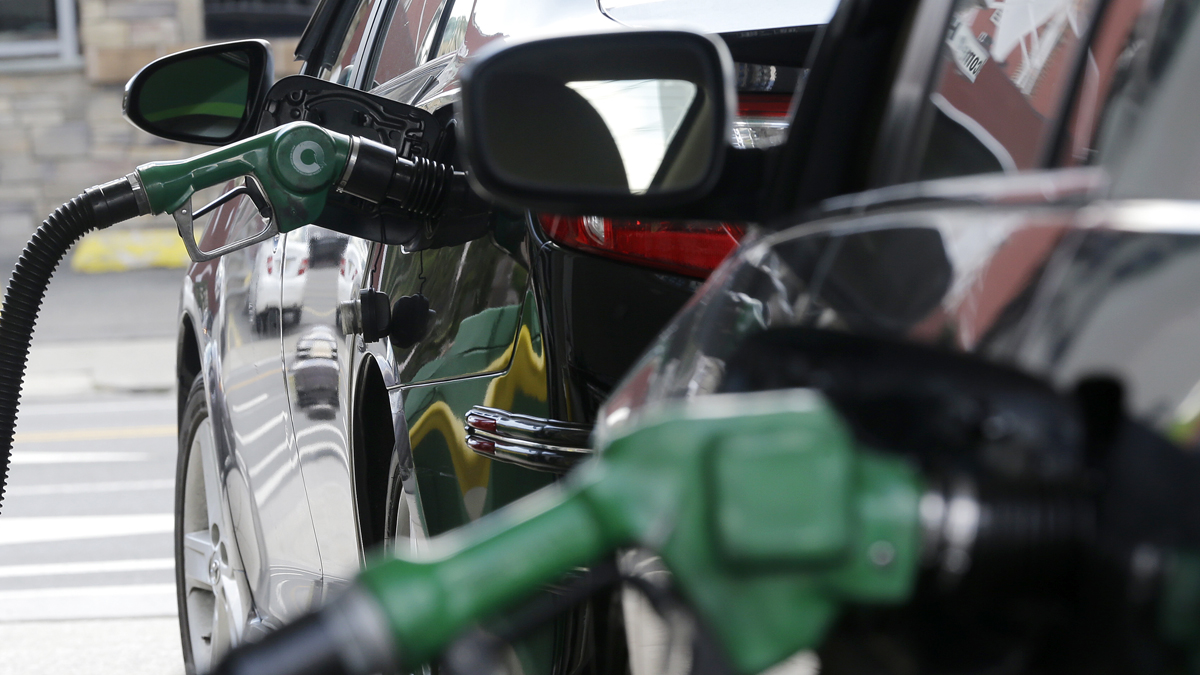 Nozzles pump gas into vehicles at a BP gas station. (Julio Cortez/AP Photo)