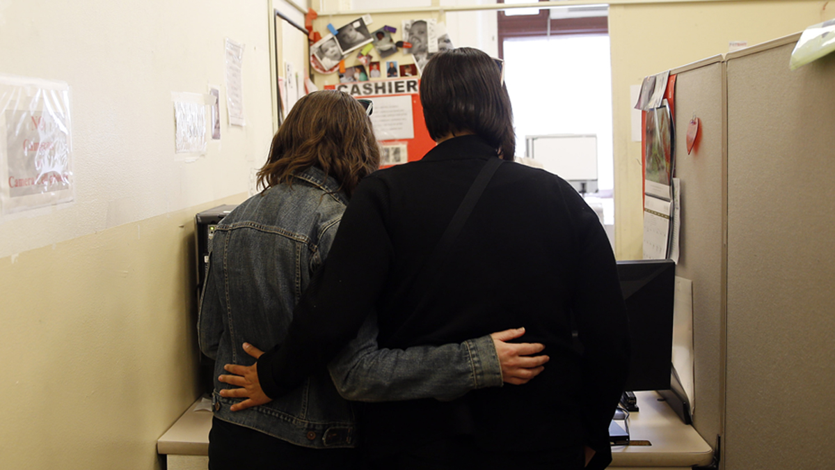  Carolyn Caton, left, and Noelle Foizen wait for their marriage license at the Philadelphia Marriage Bureau in City Hall, Tuesday, May 20, 2014, in Philadelphia. Pennsylvania's ban on gay marriage was overturned by a federal judge Tuesday. (Matt Slocum/AP Photo) 