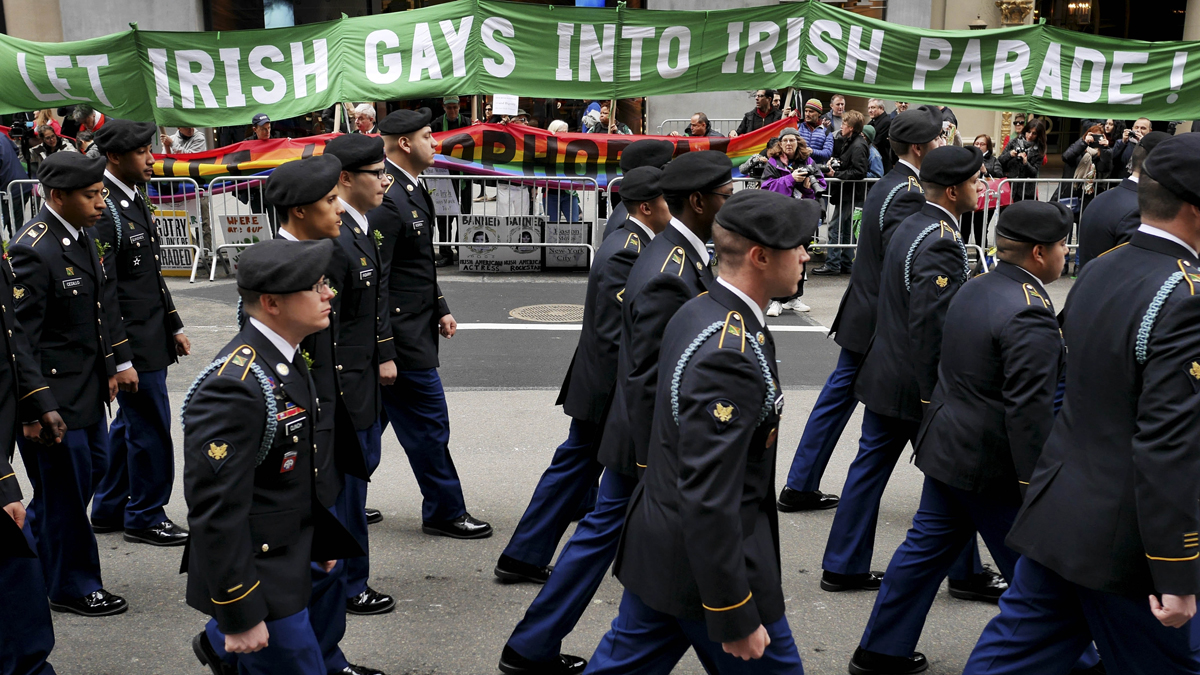 Marchers walk past a group of protesters during the St. Patrick's Day Parade in New York, Tuesday, March 17, 2015. The group was protesting the exclusion of LGBT groups from the parade. (AP Photo/Seth Wenig)