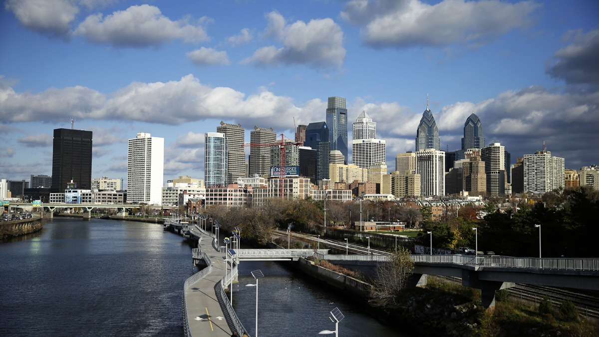 Clouds pass over the Schuylkill River and Philadelphia's skyline. Officials are considering a new plan to preserve or build 100,000 housing units over the next 10 years. (Matt Rourke/AP Photo) 
