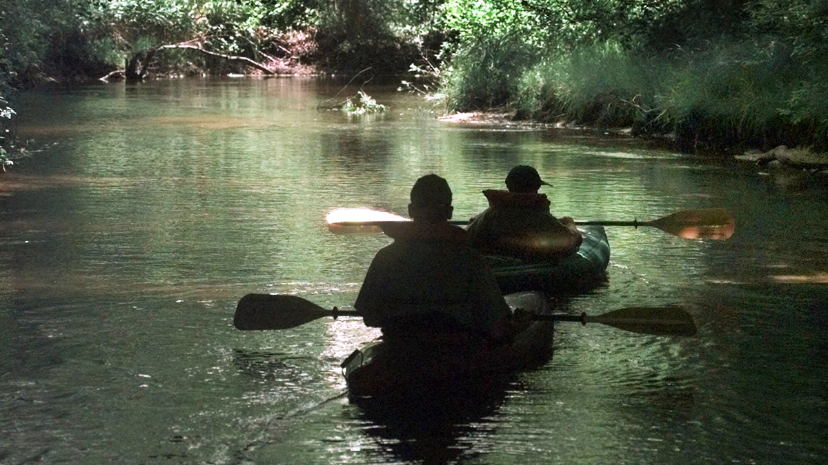 A man and his son paddle down the Toms River in Dover Township, N.J. (Daniel Hulshizer/AP Photo) 