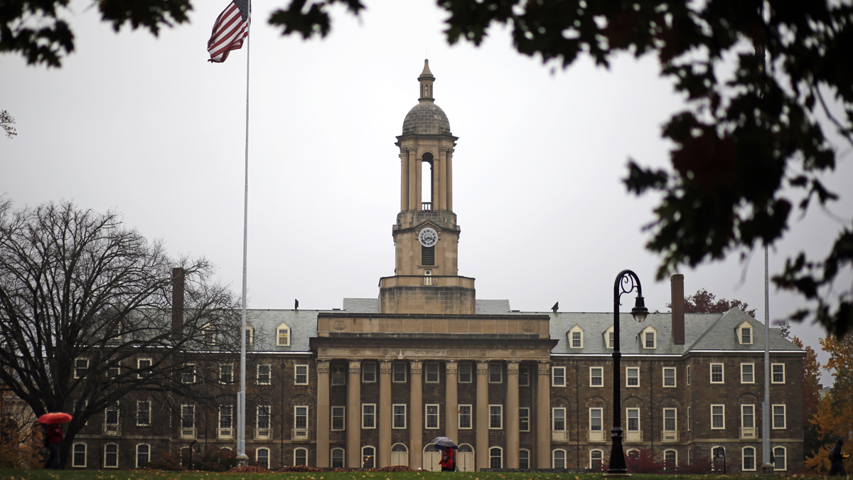  A Penn State student walks in the rain past Old Main on the Penn State main campus in State College, Pa., Wednesday, Oct. 28, 2015. (Gene J. Puskar/AP Photo) 