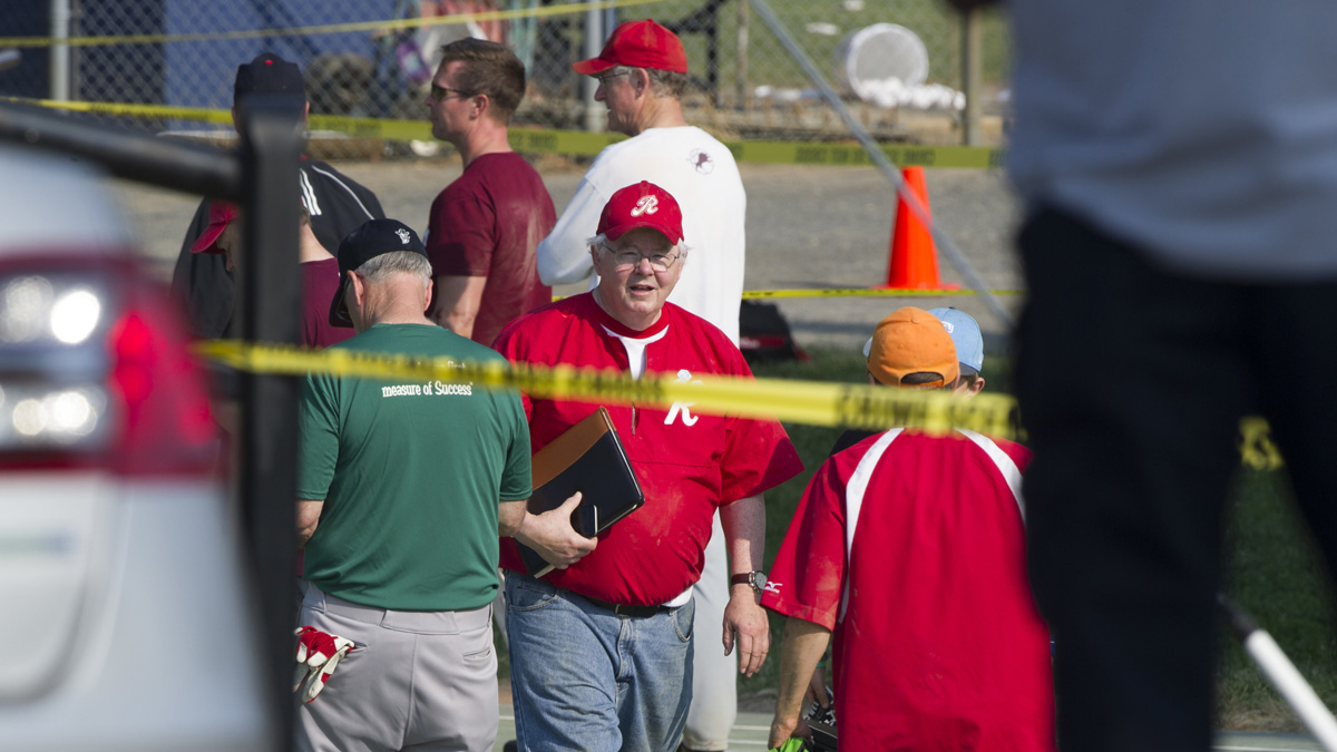  U.S. Rep. Joe Barton, R-Texas, center, and other members of the Republican congressional softball team, stand behind police tape of the scene of a multiple shooting in Alexandria, Va., Wednesday,  where House Majority Whip Steve Scalise of Louisiana was shot. (Cliff Owen/AP Photo) 