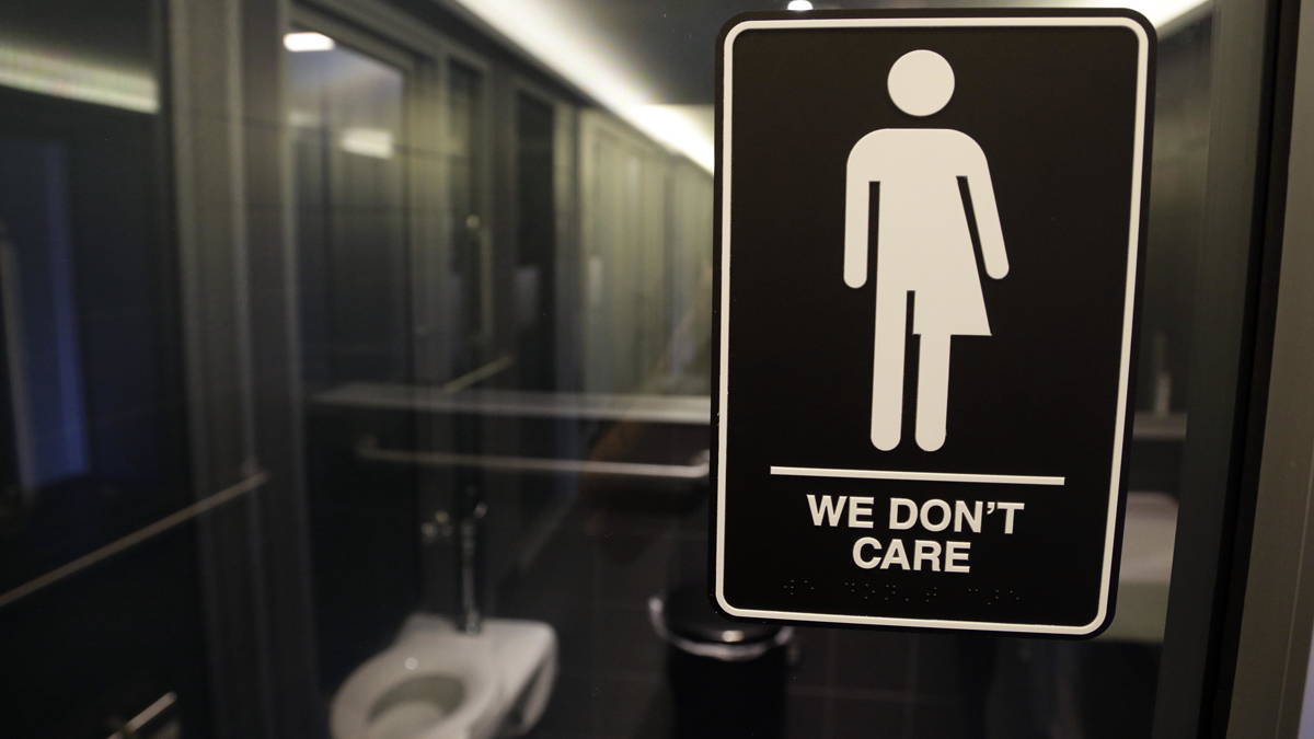  In this photo taken Thursday, May 12, 2016, signage is seen outside a restroom at 21c Museum Hotel in Durham, N.C. North Carolina is in a legal battle over a state law that requires transgender people to use the public restroom matching the sex on their birth certificate. The ADA-compliant bathroom signs were designed by artist Peregrine Honig. (Gerry Broome/AP Photo) 
