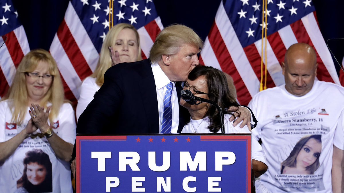 Republican presidential candidate Donald Trump hugs a woman