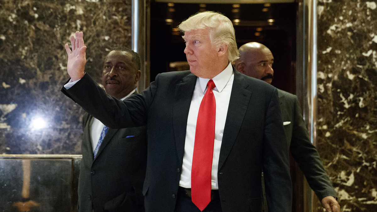  President-elect Donald Trump waves as he walks out of the elevator in the lobby of Trump Tower in New York, Friday, Jan. 13, 2017. (Evan Vucci/AP Photo) 