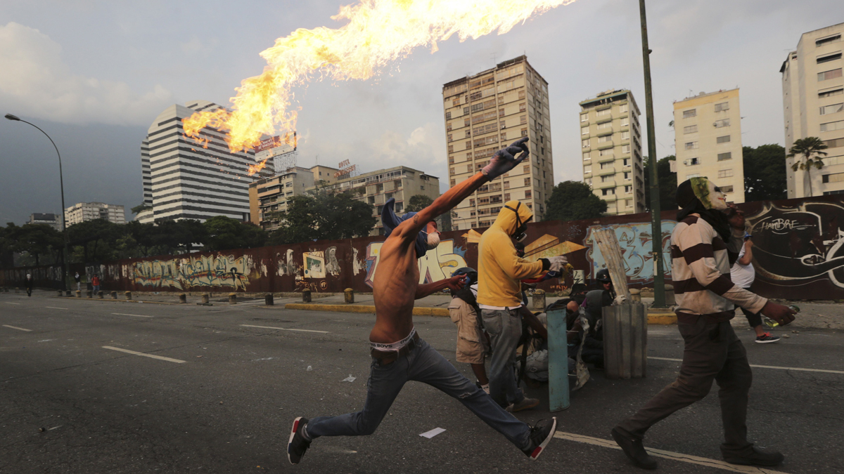  In this April 19, 2017 photo, an anti-government protesters throws a molotov bomb at security forces in Caracas, Venezuela. Tens of thousands of opponents of President Nicolas Maduro flooded the streets of Caracas in what's been dubbed the 'mother of all marches' against the embattled socialist president. (Fernando Llano/AP Photo) 