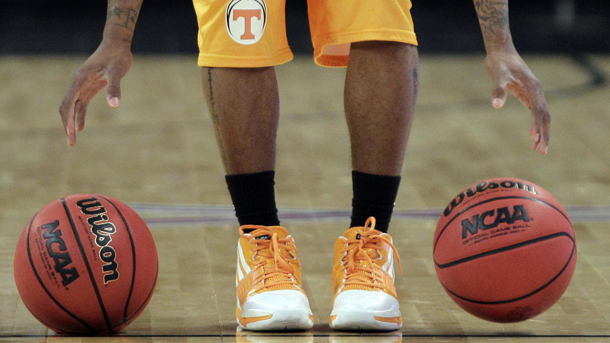  A Tennessee NCAA player bounces two basketballs during practice. (Elise Amendola/AP Photo) 
