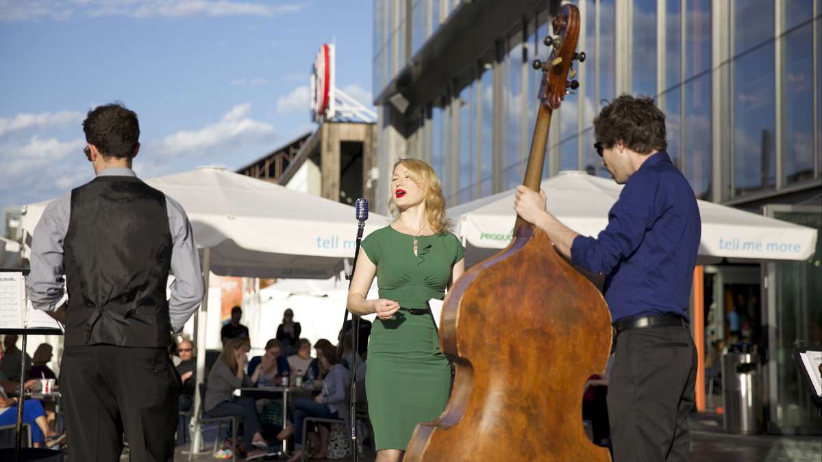 A crowd gathers to listen to Fleur Seule, a swing and jazz band performs outside of ArtsQuest at the former Bethlehem Steel Corporation plant in Bethlehem, Pa. (Lindsay Lazarski/WHYY)