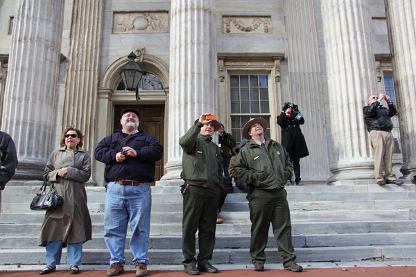 <p>A small crowd gathers on Third Street to watch the removal of the Bicentennial Bell from its home at Third and Chestnut streets, where the  bell rang out for many years at 11 a.m. and 3 p.m. (Emma Lee/for NewsWorks)</p>
