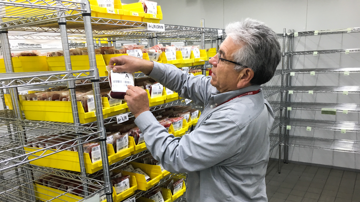 Raul Mora assesses his dwindling blood supplies at the Red Cross Chicago office in late June. (Jake J. Smith/for WHYY)