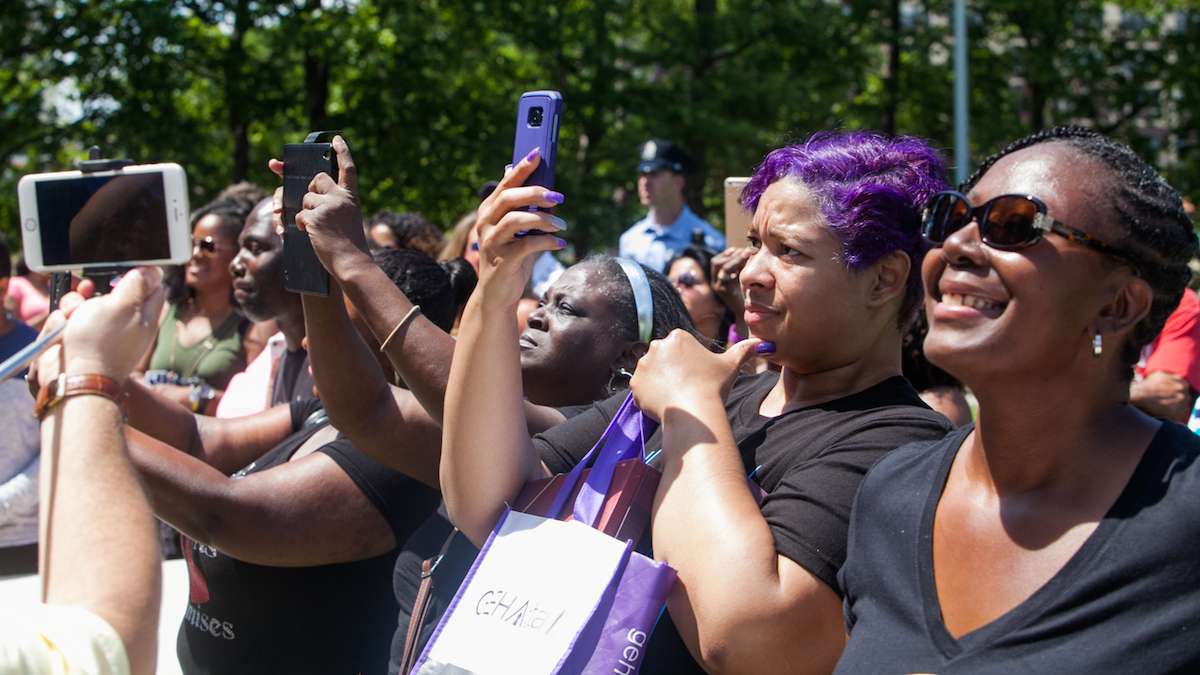 Spectators watch and take photos of Boyz II Men at the Philadelphia High School for Creative and Performing Arts Saturday.