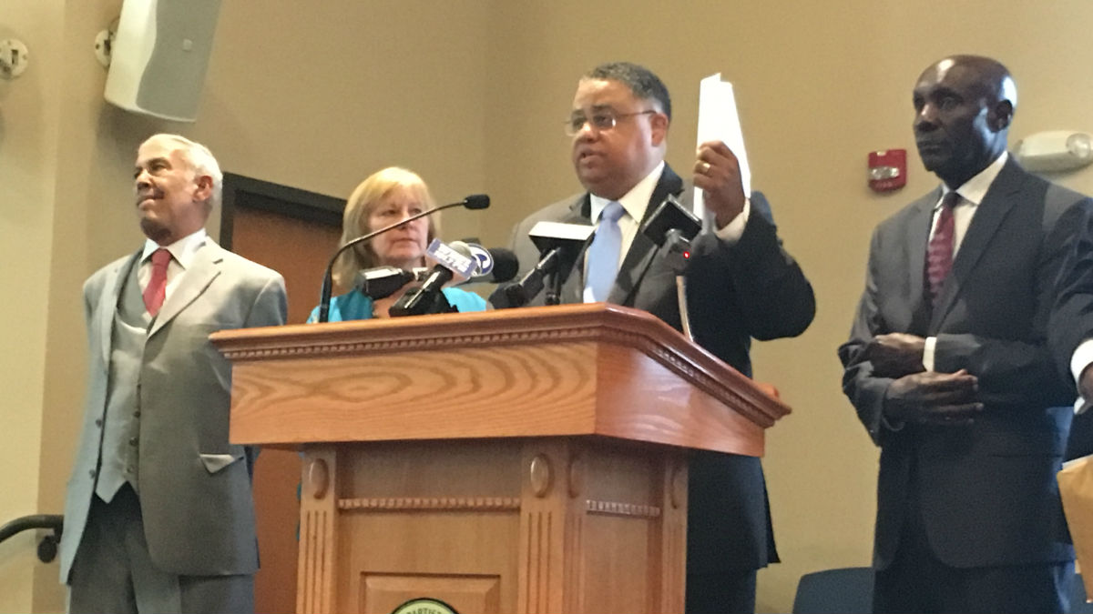  Rev. Christopher Bullock holds a letter to U.S. Attorney General Jeff Sessions asking for a federal investigation into Delaware prisons. (Mark Eichmann/WHYY) 