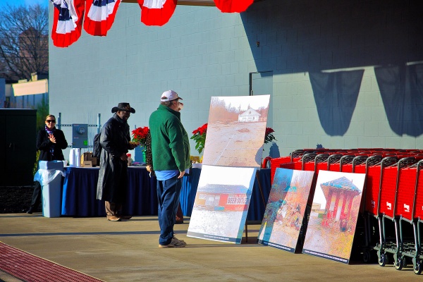 Photos were displayed outside the store to remind everyone of what the site looked like when dilapidated as recently as last year. (Bas Slabbers/for NewsWorks)