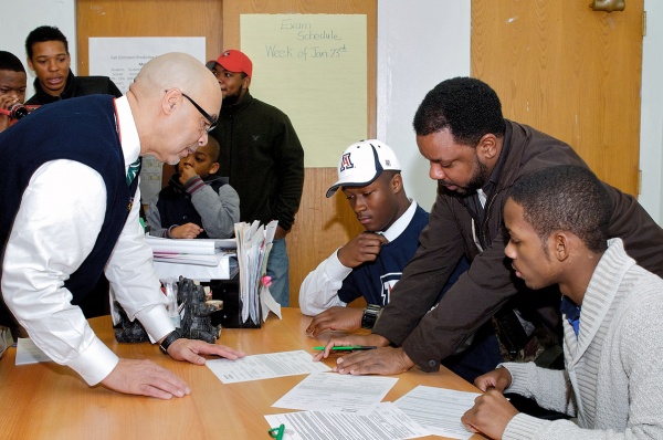 Germantown High School Bears head coach and dean of students Michael Hawkins checks out the letters before they're sent off. (Bas Slabbers/for NewsWorks)