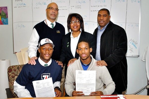 Germantown High School Bears head coach Michael Hawkins, Principal Margaret Mullen-Bavwidinsi and assistant coach Kelly Cottle join Will Parks and Myles Brooker. (Bas Slabbers/for NewsWorks)