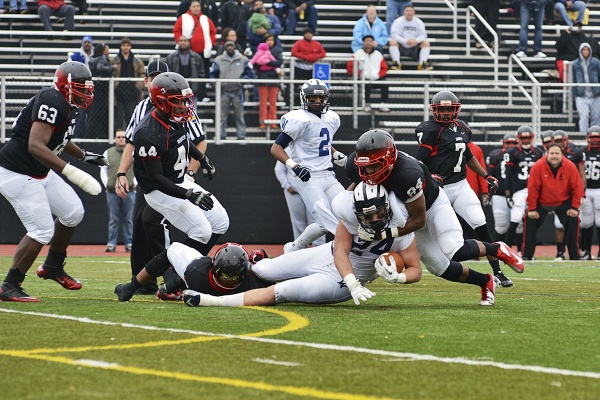 <p><p>Wyomissing's Alex Anzalone is tackled by Imhotep's Brandon Chatmon. (Bas Slabbers/for NewsWorks)</p></p>
