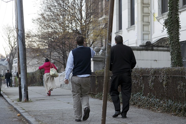 <p>GHS staffers and parents are seen walking near the school. (Bas Slabbers/for NewsWorks)</p>
