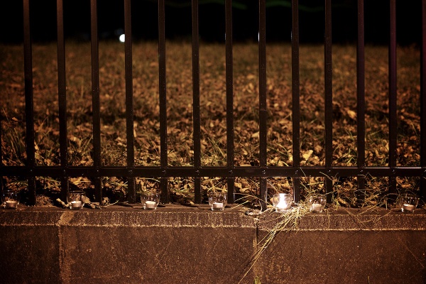 <p><p>One candle is still lit. The others along the gate got blown out. (Bas Slabbers/for NewsWorks)</p></p>
