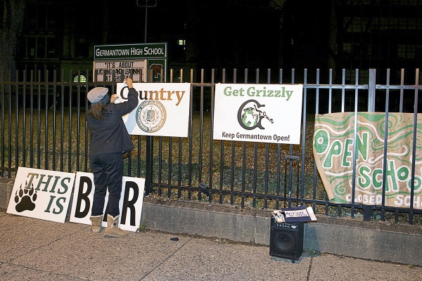 <p><p>Jasmine Rivera of Action United hangs "Keep Germantown Open" signs outside GHS before a Thursday night "vigil." (Bas Slabbers/for NewsWorks)</p></p>
