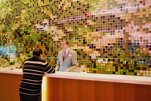 <p>At the main desk a Revel employee is seen helping a customer. (Bas Slabbers/for NewsWorks, file)</p>
