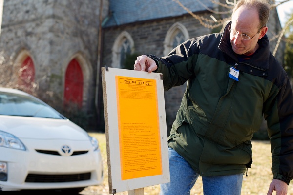 <p><p>Weinstein checks out the zoning notice posted at the 6008 Wayne Ave. property. (Bas Slabbers/for NewsWorks)</p></p>
