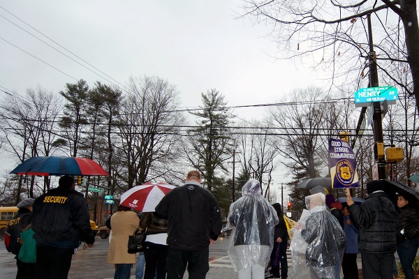 <p><p>Armed with umbrellas and rally signs, a dozen McGinn Security officers gathered on the corner of Henry Avenue and School House Lane on Tuesday to rally for better wages and working conditions. (Bas Slabbers/for NewsWorks)</p></p>
