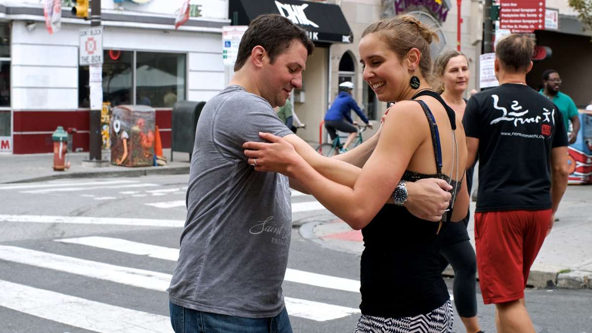 People try to find their swing dance moves at a Philly Powered Dance Party at South and Fifth streets