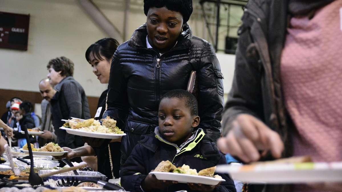 Carine Nyembo and son Daniel, 5, choose from the many options at the buffet. (Bastiaan Slabbers for NewsWorks)