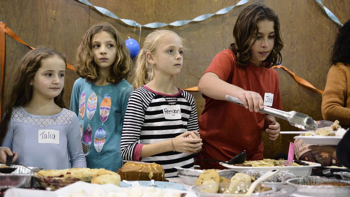Refugees from all over the world enjoy their first Thanksgiving dinner at the Old Pine Community Center on Sunday. (Bastiaan Slabbers for NewsWorks)