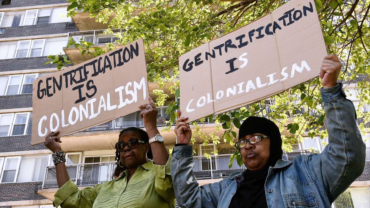 Karen Harvey, resident at Penn Wynn House for 8 years and Regina Taylor, resident for 3 years protest their imminent eviction from their apartment building, during a rally on Wednesday.
