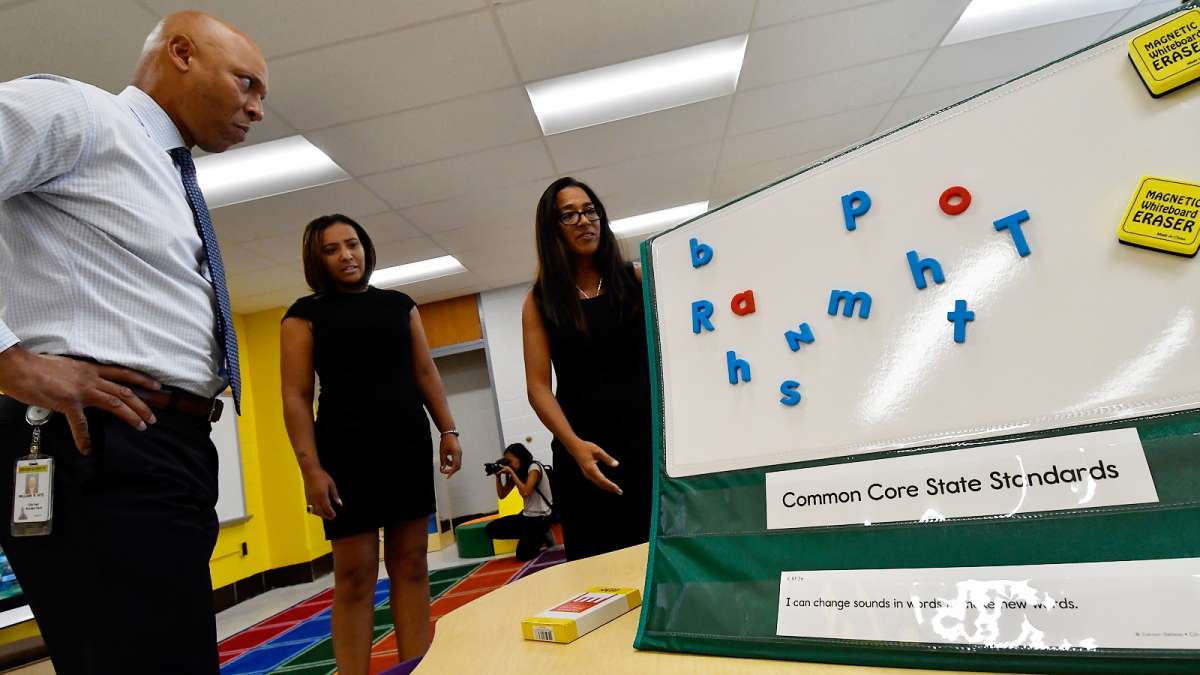Superintendent Dr. William Hite, Stearne Principal Mecca Jackson, and SPD Education facilities planner Paula Sahm demonstrate some of the learning materials at Allen M. Stearne Elementary (Bastiaan Slabbers for WHYY)