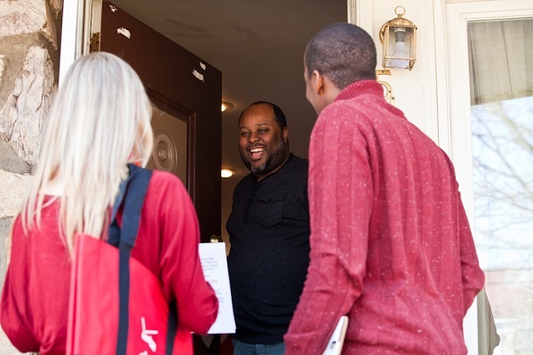 <p><p>Devon Keck comes to the door to find Verizon Cupids Jennifer Wallington and Jeremy Keys at his Roxborough home on Thursday. (Brad Larrison/for NewsWorks)</p></p>
