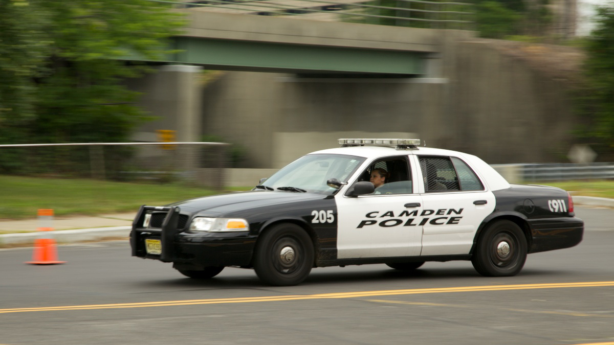  Camden Police Car going past the Fraternal Order of Police station with a passenger (Nathaniel Hamilton/NewsWorks File Photo) 
